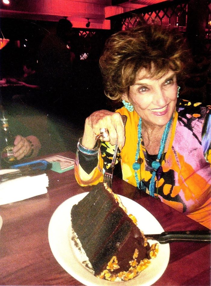 Headshot of Rosemary Rowlands, eating a cake