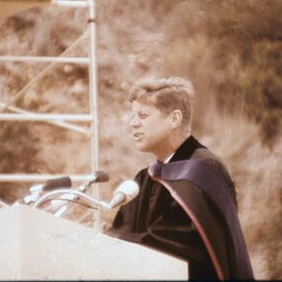 John F. Kennedy standing in front of a podium