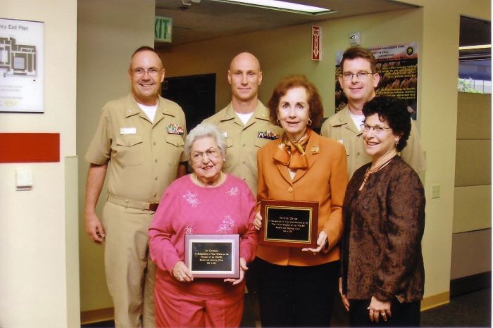 Three Navy Officer taking picture with 3 award winners