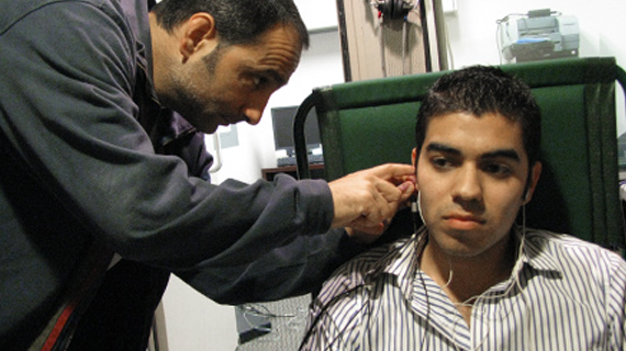 Dr. Peter Torre Examining patients ear